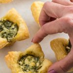 feta spinach tartlets on the white surface