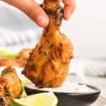 chicken wing dipped into the saude