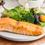 Air Fryer Salmon fillet and salad on the plate