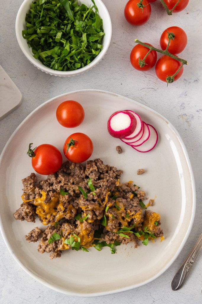ground beef casserole on the plate with cherry tomatoes and radish