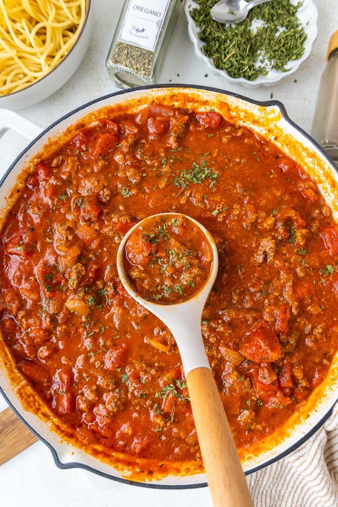 Pasta Sauce in the frying pan with ladle in the middle.