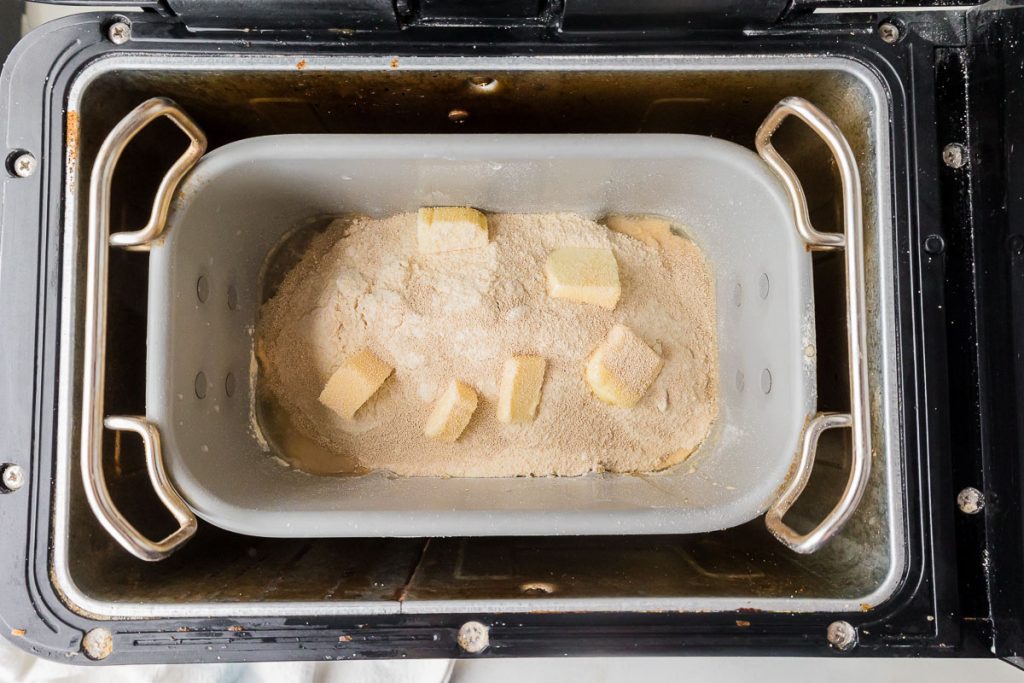 zojirushi machine with all ingredients ready to make bread