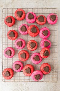 Close-up of soft chocolate heart-shaped cookies arranged on a cooling rack. perfect for a sweet homemade treat.