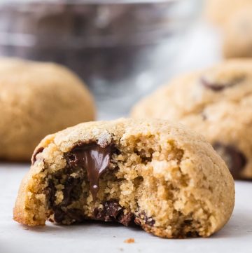 Freshly milled barley chocolate chip cookies stacked on a plate, soft and chewy homemade cookies made with whole grain barley flour.