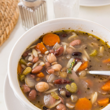 Hearty 16 bean soup with vegetables and orzo in a bowl, thick and comforting homemade one-pot meal