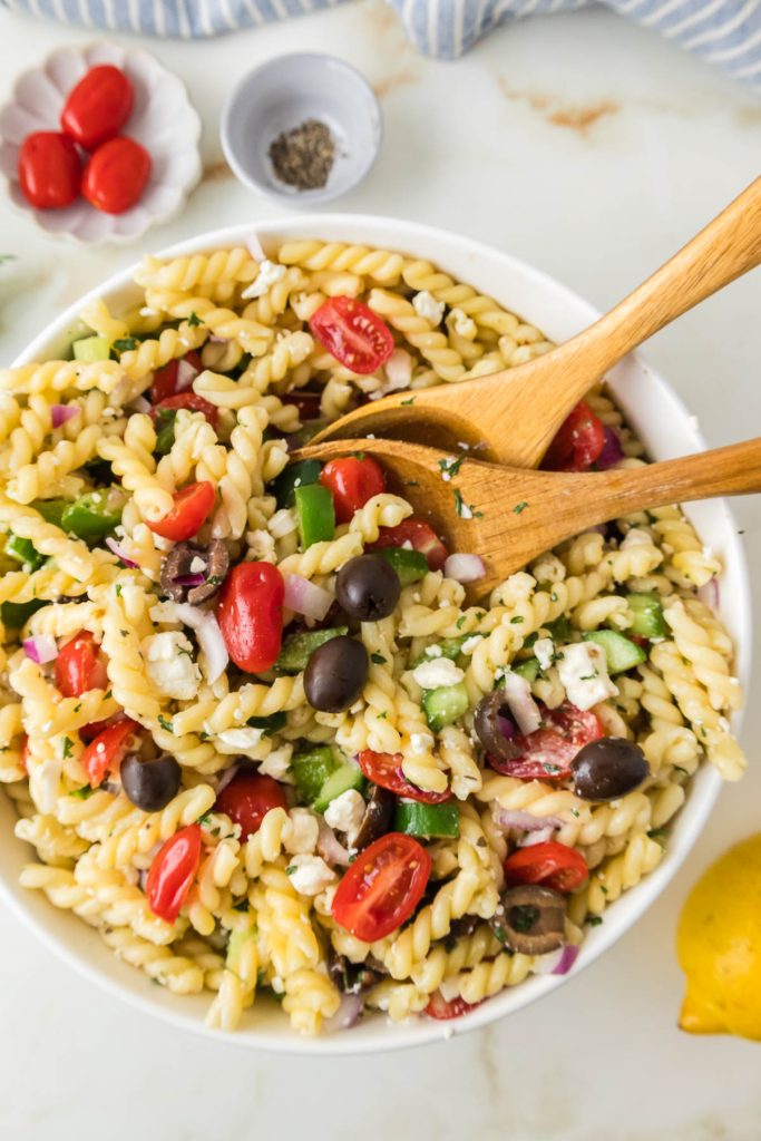 Greek pasta salad with veggies in the bowl. 