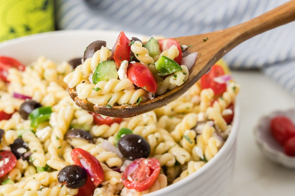 greek pasta being served on spatula