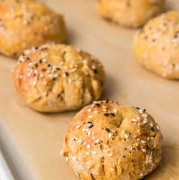 Homemade healthy bagels on a baking sheet with a soft and chewy texture.
