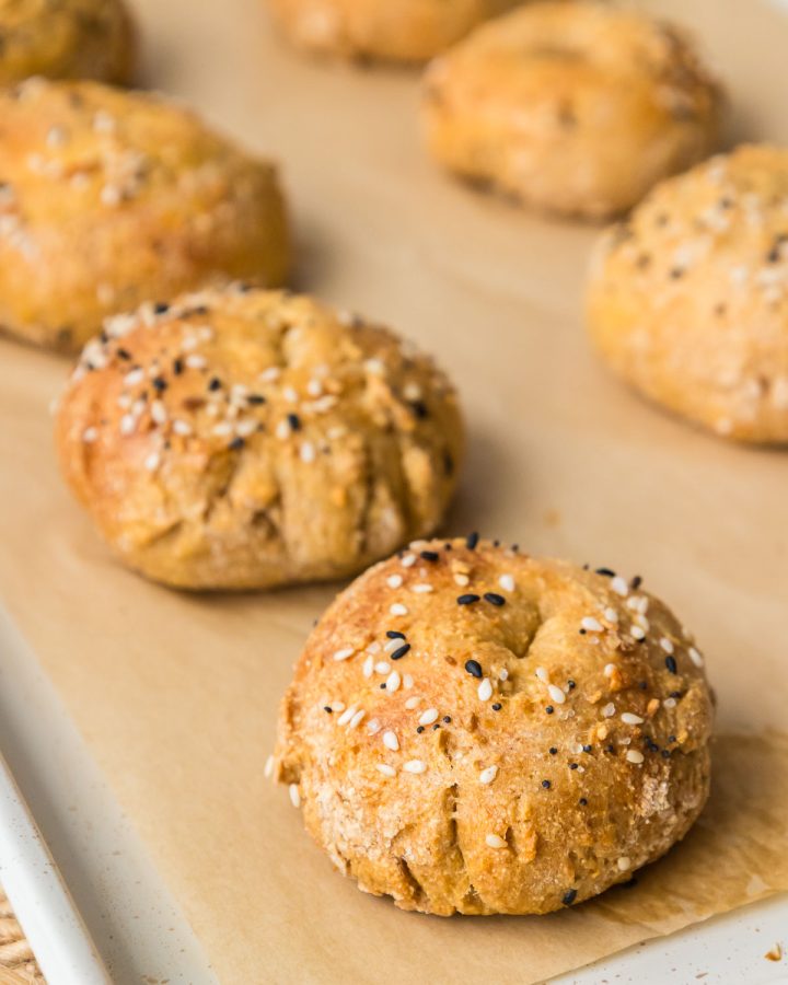Homemade healthy bagels on a baking sheet with a soft and chewy texture.