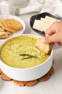 Creamy baked asparagus dip made with asparagus, Parmesan, and yogurt, served warm for dipping.