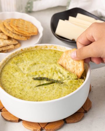 Creamy baked asparagus dip made with asparagus, Parmesan, and yogurt, served warm for dipping.