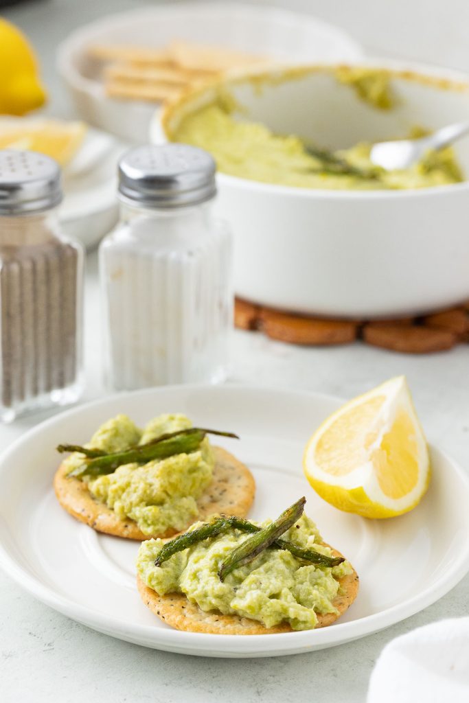Asparagus Dip on the cracker on the plate.