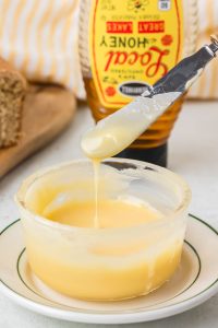 Homemade honey butter made with butter and honey, blended until smooth and creamy and served in a small bowl.