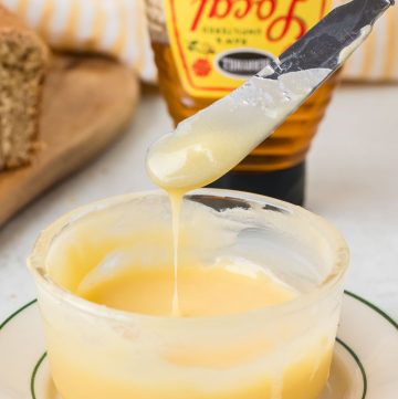 Homemade honey butter made with butter and honey, blended until smooth and creamy and served in a small bowl.