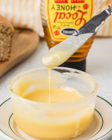 Homemade honey butter made with butter and honey, blended until smooth and creamy and served in a small bowl.