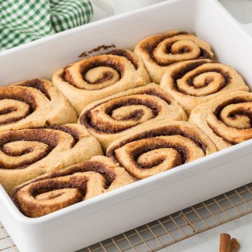 Soft cinnamon rolls made with freshly milled hard white wheat flour, filled with cinnamon sugar and topped with creamy icing.
