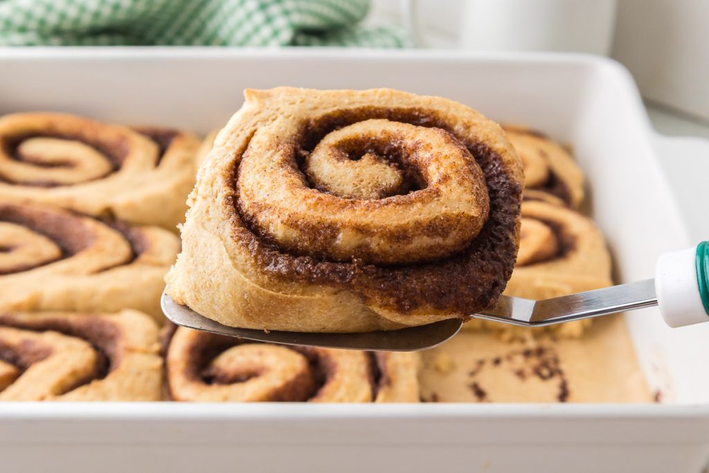 Cinnamon roll made with Freshly Milled Flour served on spatula