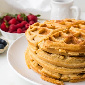 Freshly milled flour waffles served with fresh berries and maple syrup