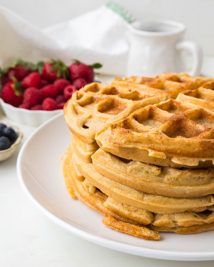 Freshly milled flour waffles served with fresh berries and maple syrup