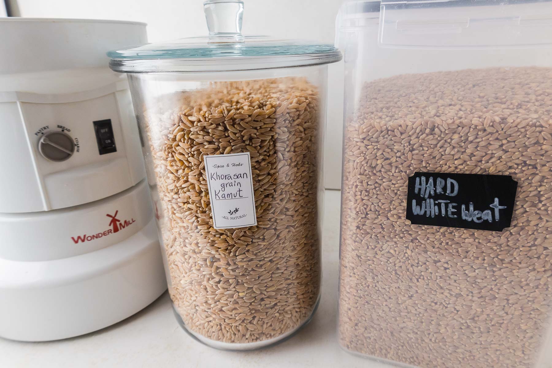 Eva's WonderMill grain mill and jars of wheat berries